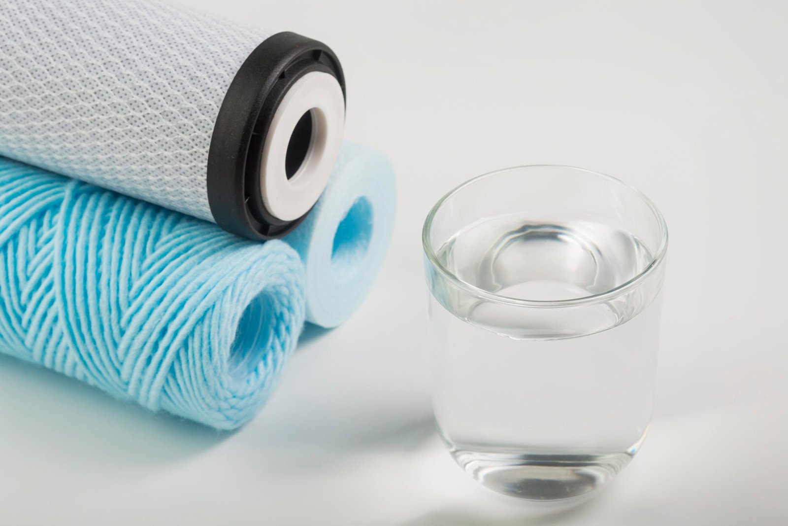 Clean water filtration cartridges with glass of purified drinking water